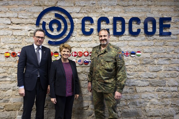 Swiss Federal President Viola Amherd, center, poses with Martin Michelet, Ambassador of Switzerland to Estonia, left, and Lieutenant Colonel Bernard G. Hoffmann, Deputy Director and Chief of Staff NAT ...