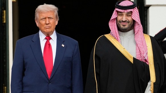 FILE - President Donald Trump stands with Saudi Arabia's Crown Prince Mohammed bin Salman on his visit to the White House, Nov. 18, 2025, in Washington. (AP Photo/Mark Schiefelbein, File)
Donald  ...