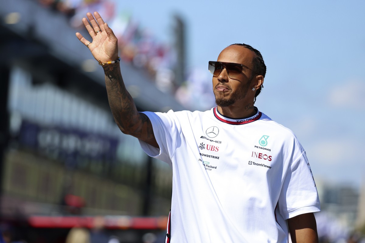 Mercedes driver Lewis Hamilton of Britain waves to fans as he arrives for the driver's parade ahead of the Australian Formula One Grand Prix at Albert Park in Melbourne, Sunday, April 2, 2023. (A ...