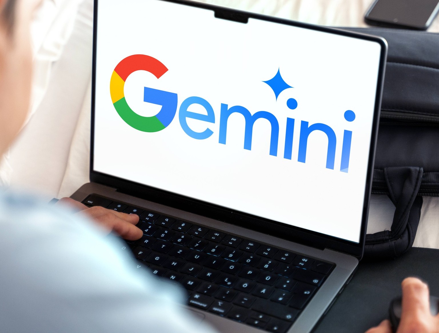 February 10, 2024: Man at laptop computer with the AI chatbot Google Gemini logo on the screen. PHOTOMONTAGE *** Mann an Laptop Computer mit dem KI-Chatbot Google Gemini Logo auf dem Bildschirm. FOTOM ...