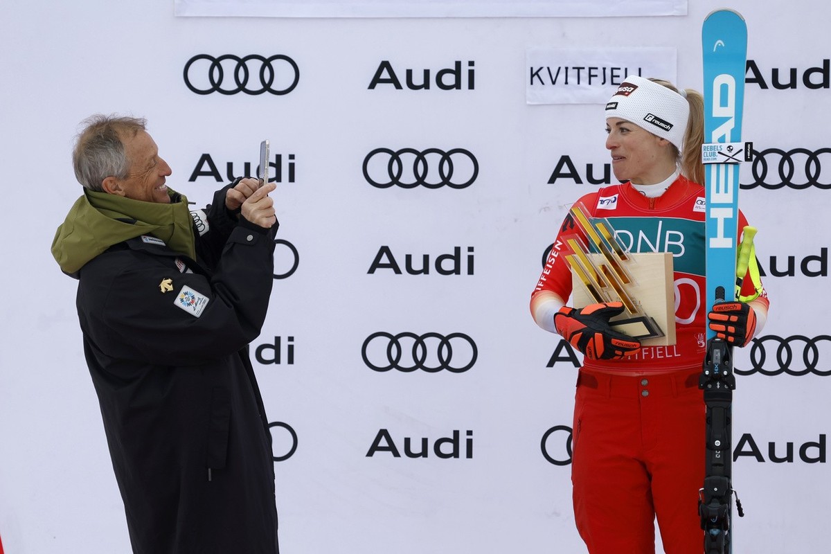 Switzerland's Lara Gut Behrami, right, winner of an alpine ski, women's World Cup super-G race, is photographed by her father Pauli Gut, in Kvitfjell, Norway, Saturday, March 2, 2024. (AP Ph ...