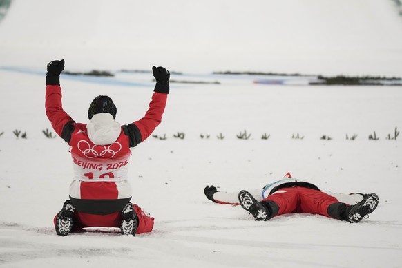 Stefan Kraft, of Austria, celebrates with teammate Daniel Huber after they won gold in the men&#039;s team ski jumping eventat the 2022 Winter Olympics, Monday, Feb. 14, 2022, in Zhangjiakou, China. ( ...