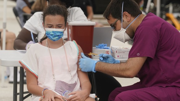 Francesca Anacleto, 12, receives her first Pfizer COVID-19 vaccine shot from nurse Jorge Tase, Wednesday, Aug. 4, 2021, in Miami Beach, Fla. On Tuesday, the CDC added more than 50,000 new COVID-19 cas ...