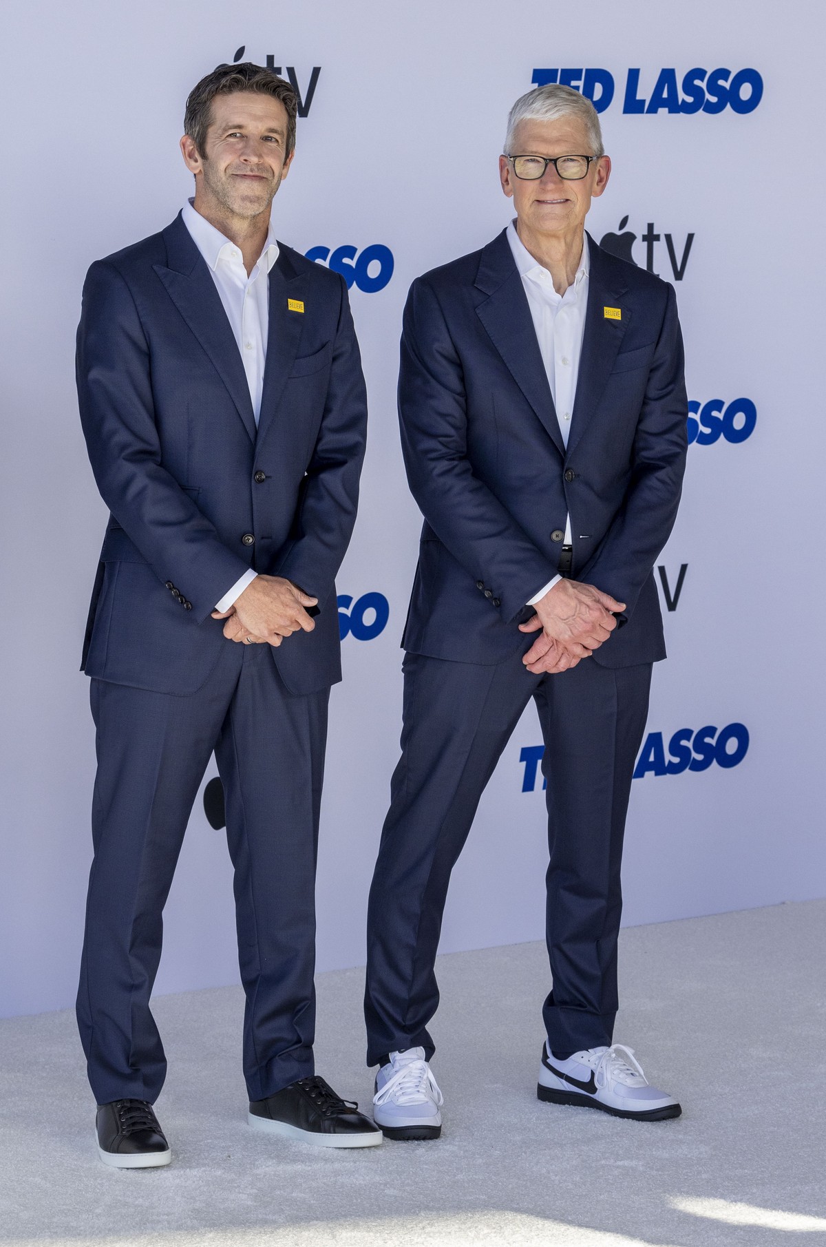 epa13136518 John Ternus (L) and Tim Cook (R) arrive for the world premiere of the fourth season of the television series 'Ted Lasso' at the Academy Museum of Motion Pictures in Los Angeles,  ...