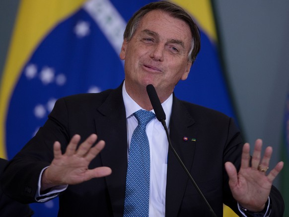 epa09512182 Brazilian President Jair Bolsonaro participates in a ceremony of Modernization of the Standards of Safety and Health at Work at the Palacio do Planalto in Brasilia, Brazil, 07 October 2021 ...