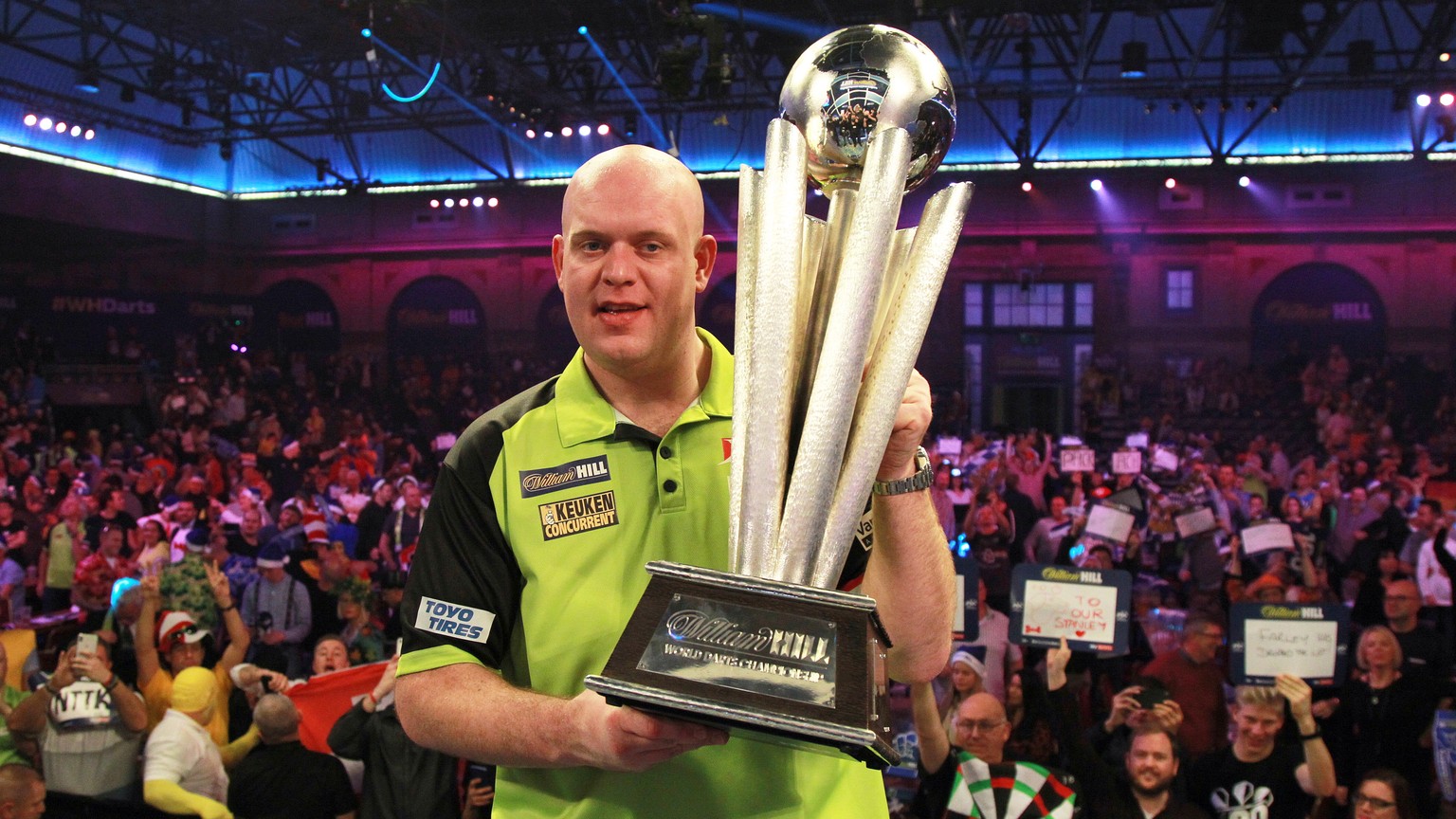 epa07257608 Dutch Michael van Gerwen celebrates with the trophy after winning the PDC World Championship final match against British Michael Smith at the Alexander Palace in North London, Britain, 01  ...