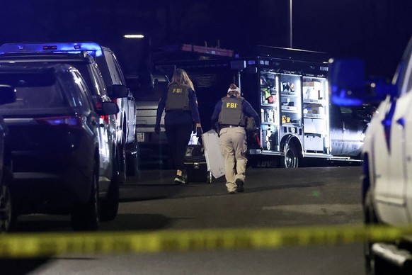 Law enforcement officers are seen outside a storage facility where a suspect in the shooting at Brown University was found dead, Thursday, Dec. 18, 2025, in Salem, N.H. (AP Photo/Reba Saldanha)
Brown  ...