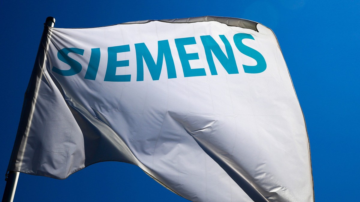 A flag with the logo of German technology firm Siemens is seen at its branch in Berlin in this May 30, 2014 file photo. Germany's Siemens warned on July 31, 2014 that its energy business faced ch ...