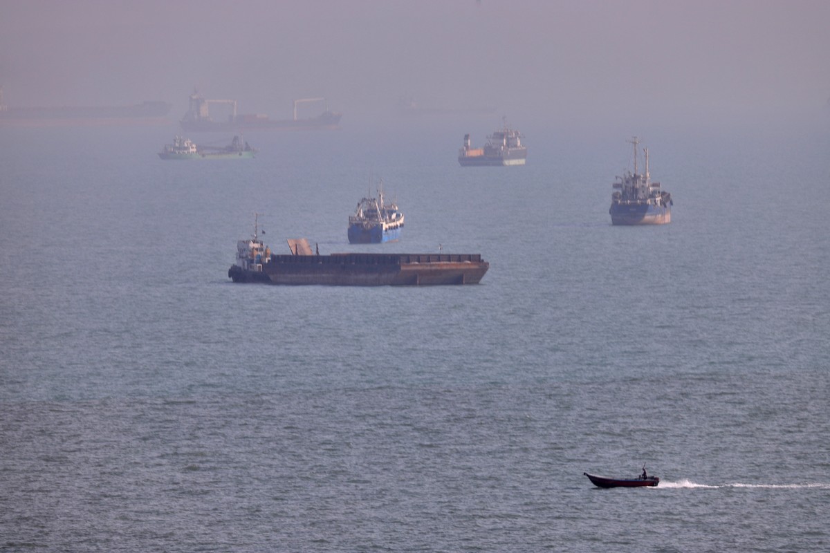 FILE - A small boat sails past cargo ships and other commercial vessels anchored in the Strait of Hormuz off Bandar Abbas, Iran, Wednesday, Aug. 5, 2026. (Amirhosein Khorgooi/ISNA via AP, File)
Iran U ...