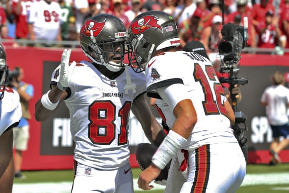 Tampa Bay Buccaneers wide receiver Antonio Brown (81) celebrates his 62-yard touchdown reception with quarterback Tom Brady (12) during the first half of an NFL football game against the Miami Dolphin ...