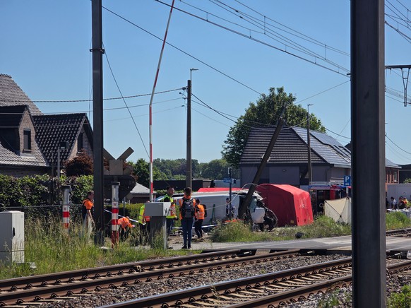 Rescue workers on the scene of a crash between a train and vehicle in Buggenhout, Belgium, Tuesday, May 26, 2026. (AP Photo/Koen Baten)
Belgium Crash