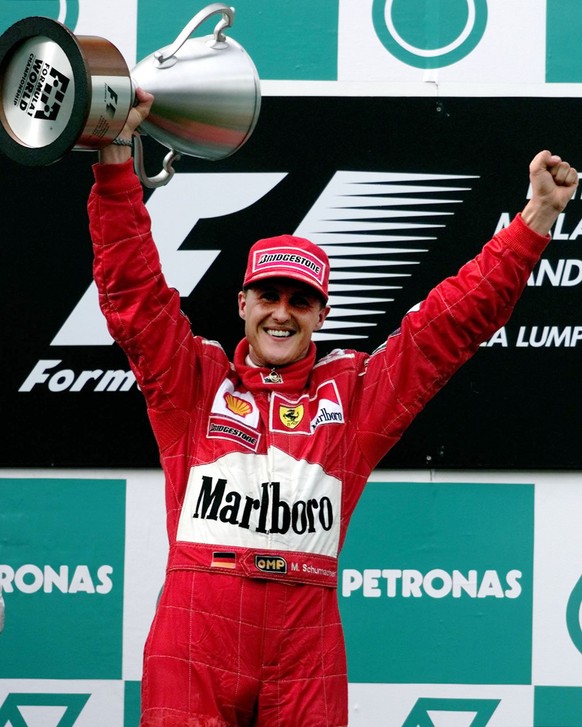 Germany&#039;s Michael Schumacher holds aloft the trophy for winning the Malaysian Grand Prix on Sunday October 22, 2000. Schumacher&#039;s victory ensured his Ferrari team their tenth Constructors&#0 ...