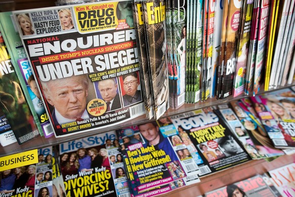 FILE - This July 12, 2017, file photo shows the cover of an issue of the National Enquirer featuring President Donald Trump at a store in New York. Karen McDougal, a former Playboy model who said she  ...