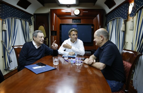 French President Emmanuel Macron, center, German Chancellor Olaf Scholz, right, and Italian Prime Minister Mario Draghi travel on board a train bound to Kyiv after departing from Poland, Thursday, Jun ...