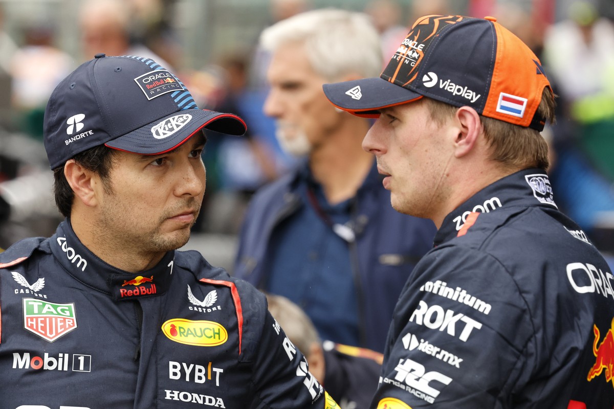 FILE- Red Bull driver Max Verstappen of the Netherlands, right, who clocked the fastest time, speaks with Red Bull driver Sergio Perez of Mexico , who clocked the third fastest time during qualificati ...