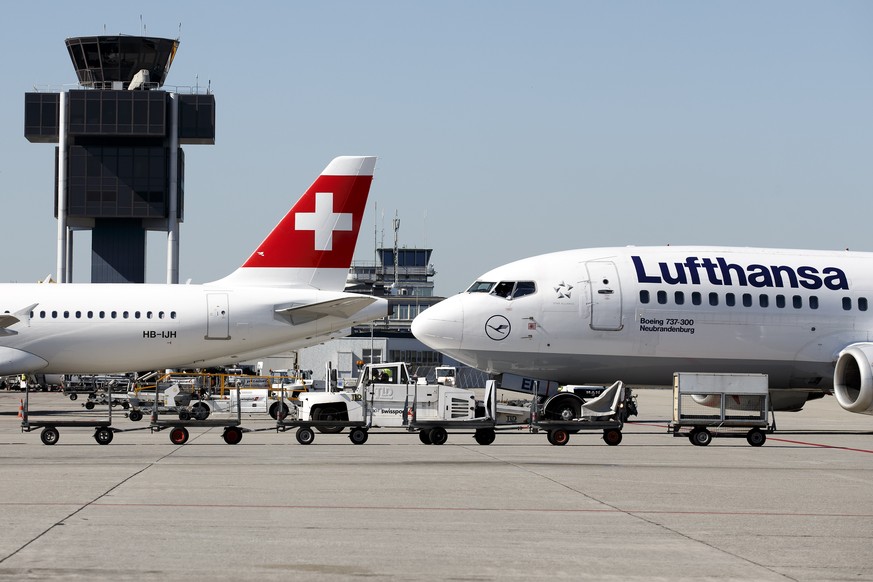 An aircraft (Boeing 737-300 D-ABEN) of the Lufthansa is push back next to an aircraft (Airbus A320 HB-IJH) of the Swiss International Air Lines at the Geneva Airport, in Geneva, Switzerland, Wednesday ...