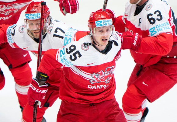 FILE - Denmark's Nick Olesen (95) celebrates with teammates after scoring the winning goal in a quarterfinal game between Canada and Denmark at the hockey world championships, May 22, 2025, in He ...