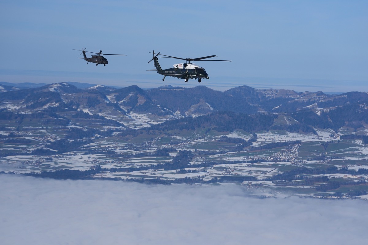 Marine One, carrying President Donald Trump, is escorted by military helicopter during his transfer to Davos after arriving at the airport in Zurich, Switzerland, Wednesday, Jan. 21, 2026. (AP Photo/E ...