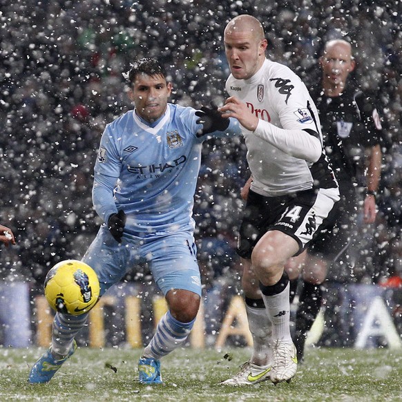 Manchester City's Sergio Aguero, center right, fights for the ball against Fulham's Philippe Senderos, right, and Stephen Kelly, bottom left, during their English Premier League soccer match ...