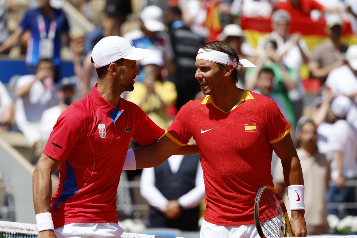 epa11652233 (FILE) - Rafael Nadal (R) of Spain and Novak Djokovic of Serbia greet each other ahead of their Men's Singles second round match at the Tennis competitions in the Paris 2024 Olympic G ...