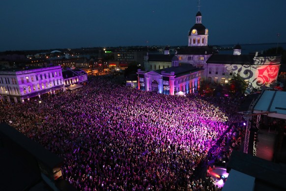 People who could not get a ticket gather in Springer Market square to listen to the Tragically Hip in downtown Kingston, Ontario, Saturday, Aug. 20, 2016. The Tragically Hip mixed fan favourites, newe ...