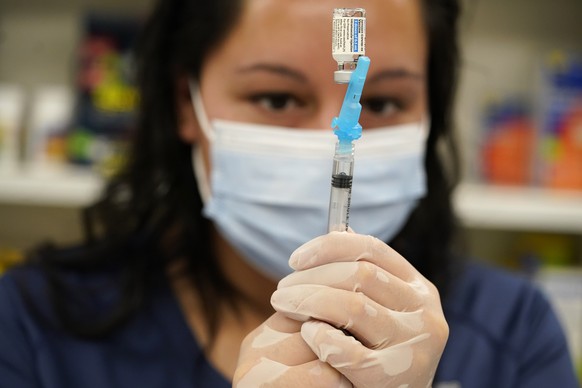 Pharmacist Claudia Corona-Guevara draws a shot of Johnson &amp; Johnson COVID-19 vaccine in the pharmacy of National Jewish Hospital for distribution early Saturday, March 6, 2021, in east Denver. Vol ...