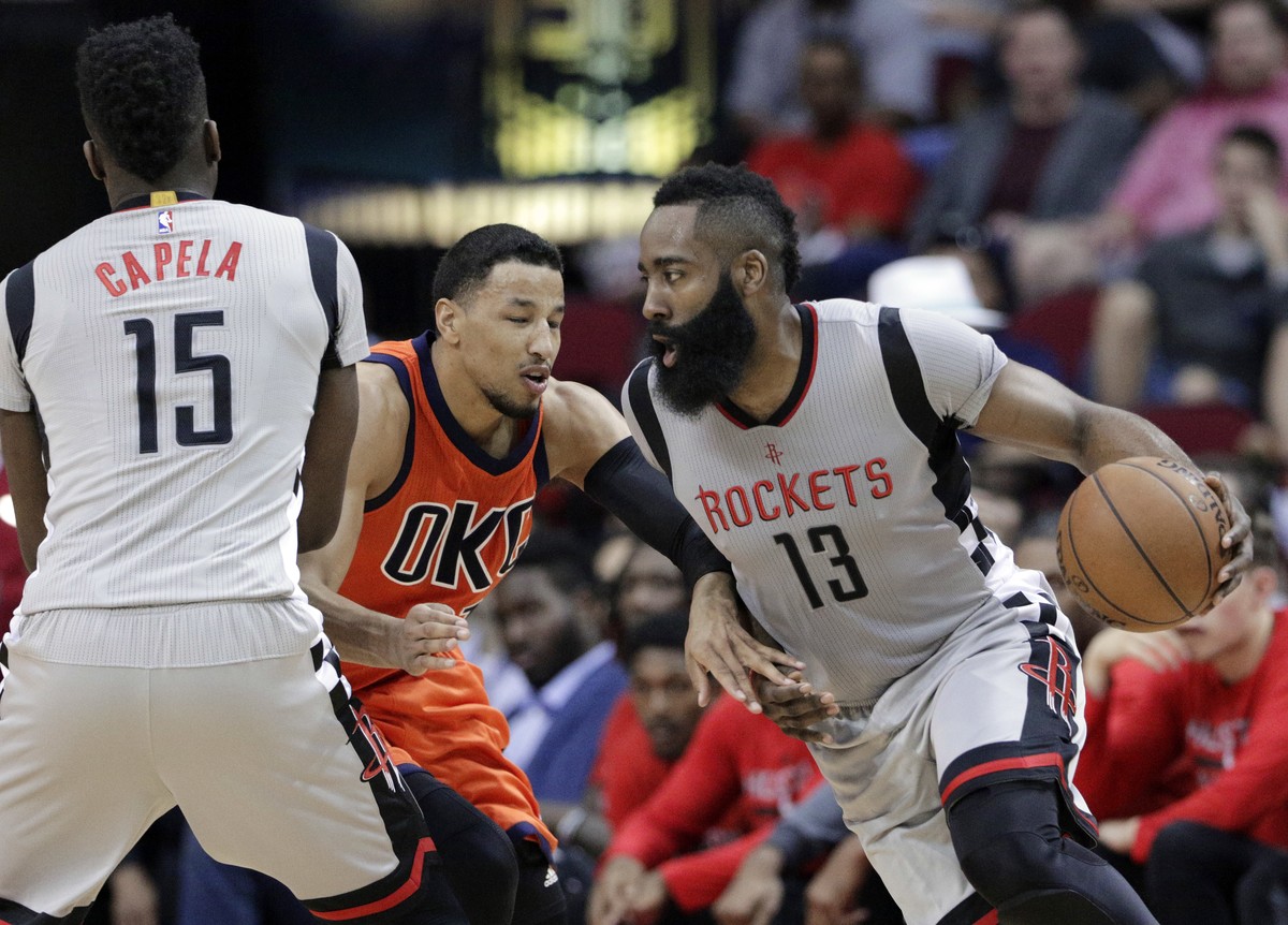 Houston Rockets' Clint Capela (15) blocks Oklahoma City Thunder's Andre Roberson as James Harden (13) drives around them during the second half of an NBA basketball game in Houston, Sunday,  ...