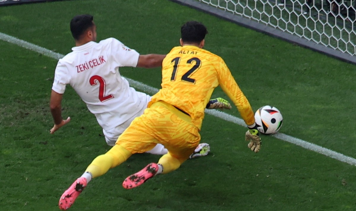 epa11430727 Goalkeeper Altay Bayindir (R) and Mehmet Zeki Celik (L) of Turkey chase a misspass by teammate Samet Akaydin of Turkey (unseen) which ended up as an own goal to make the score 0-2 during t ...