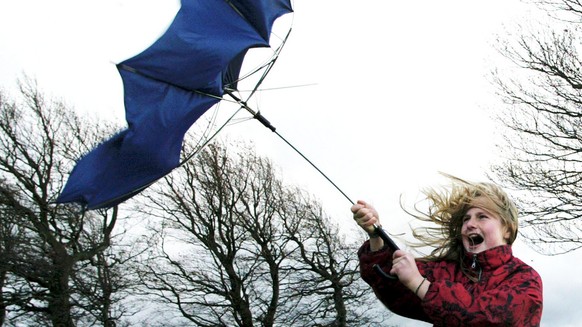 Jeanette tries to hold her umbrella as heavy storms sweep over the Schauinsland hill near Freiburg, southwestern Germany, Sunday Oct. 27, 2002. Storm winds swept across Germany on Sunday, leaving at l ...