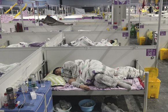 Residents rests at a temporary hospital converted from the National Exhibition and Convention Center to quarantine COVID-positive people in Shanghai, China on April 18, 2022. Interviews with family me ...