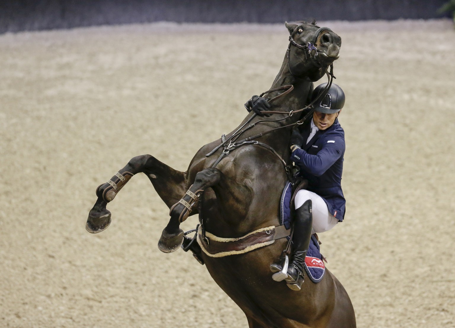 Austria&#039;s Max Kuhner hangs on to his horse Cornet Kalua, who balked at a jump in the FEI World Cup equestrian jumping speed class in Omaha, Neb., Thursday, March 30, 2017. (AP Photo/Nati Harnik)