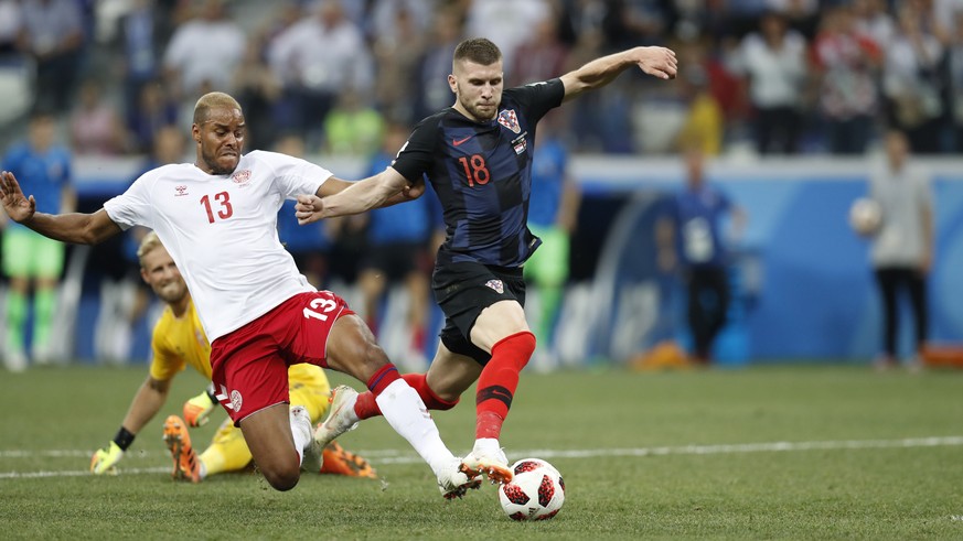 Denmark&#039;s Mathias Jorgensen, left, tries to stop Croatia&#039;s Ante Rebic during the round of 16 match between Croatia and Denmark at the 2018 soccer World Cup in the Nizhny Novgorod Stadium, in ...