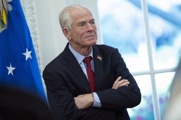 epa12021677 Peter Navarro, Senior Counselor to the President for Trade and Manufacturing watches as United States President Donald J Trump signs executive orders proclamations at the White House in Wa ...
