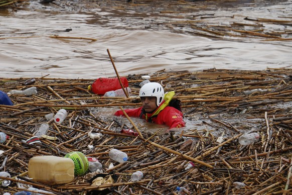 epa10245256 A rescue diver inspects through flood debris in the sea for missing people at Aghia Pelagia, Heraklion, Crete island, Greece, 15 October 2022. A 50-year-old man was found dead at Aghia Pel ...
