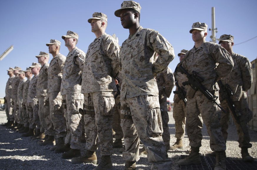 FILE - In this Jan. 15, 2018, file photo, U.S. Marines watch during the change of command ceremony at Task Force Southwest military field in Shorab military camp of Helmand province, Afghanistan. The  ...