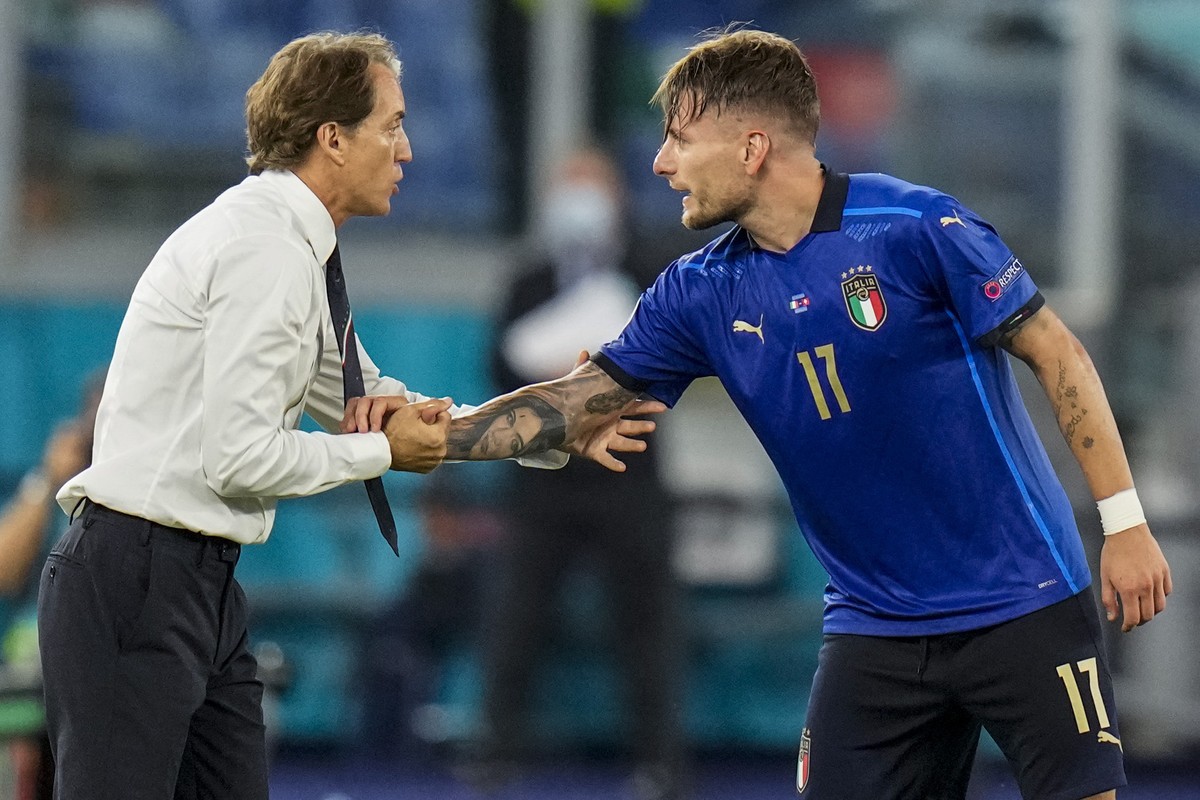 Italy's Ciro Immobile, right, is congratulated by Italy's manager Roberto Mancini after scoring his side third goal during the Euro 2020 soccer championship group A match between Italy and S ...