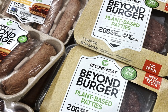 FILE - Beyond Meat products are seen in a refrigerated case inside a grocery store in Mount Prospect, Ill., Saturday, Feb. 19, 2022. Beyond Meat is cutting about 200 jobs and lowering its full-year re ...