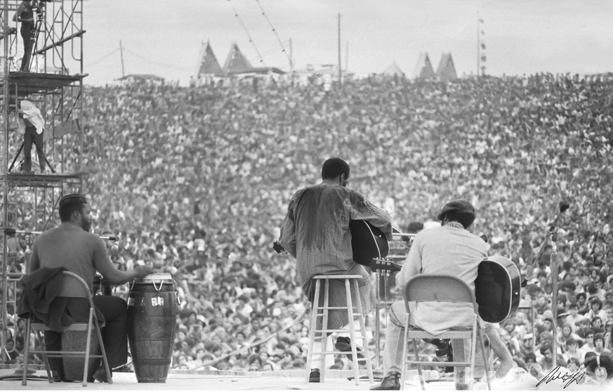 This August, 1969 photo shows Richie Havens as he performs during Woodstock in Bethel, N.Y. The photo is only one of hundreds made by photographer Mark Goff who, at the time, worked for an underground ...