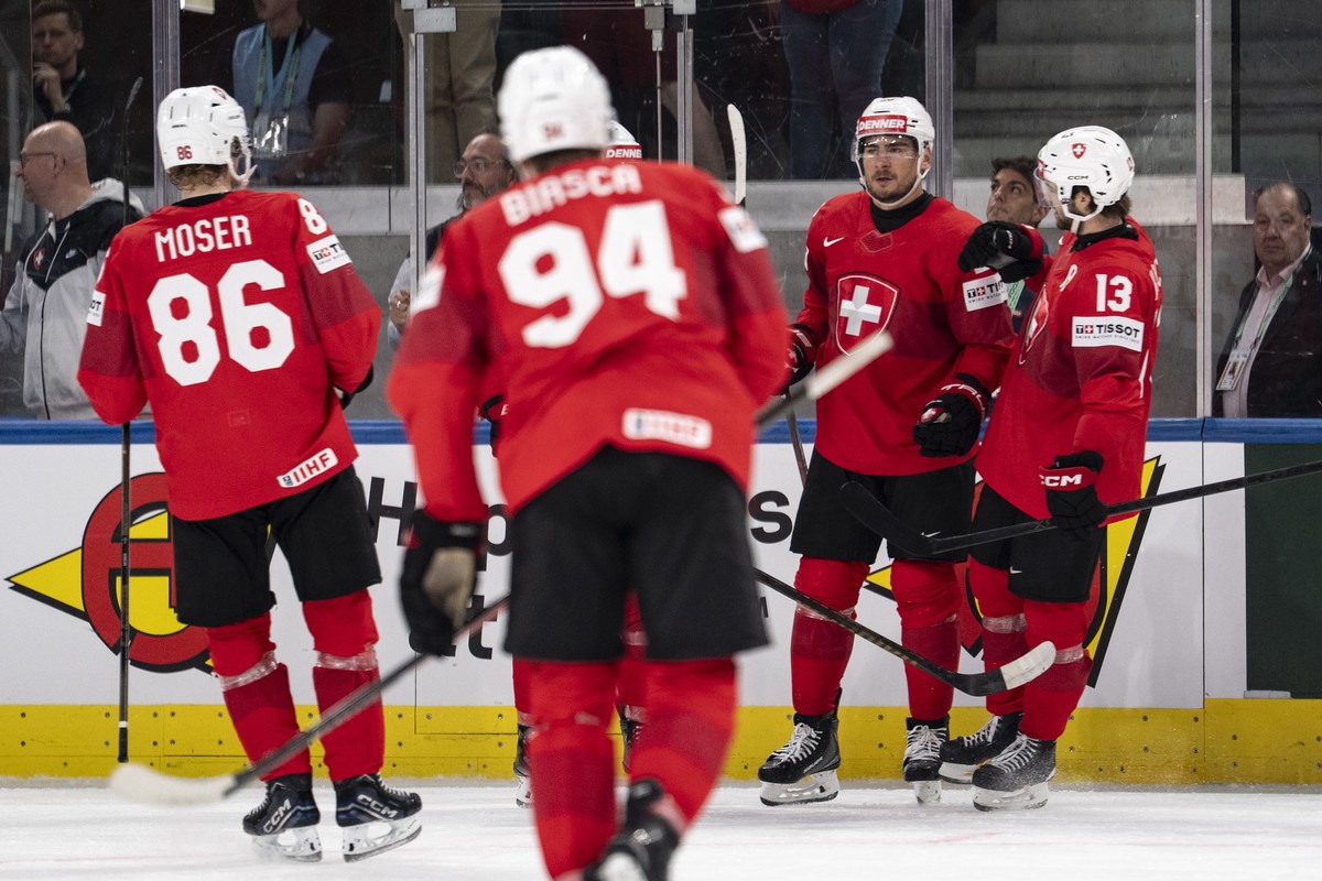 From left: Switzerland's Janis Moser, Switzerland's Attilio Biasca, Switzerland's Timo Meierand Switzerland's Nico Hischier celebrate after scoring the fourth goal during the 2026  ...