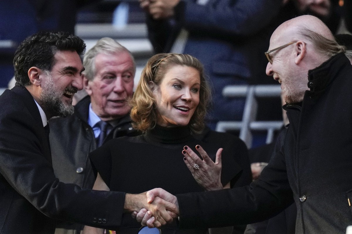 Manchester United's Chairman Avie Glazer, right, and Newcastle United's Chairman Yasir Al-Rumayyan, left, shake hands and Newcastle's Club Director Amanda Staveley, centre, gestures bef ...