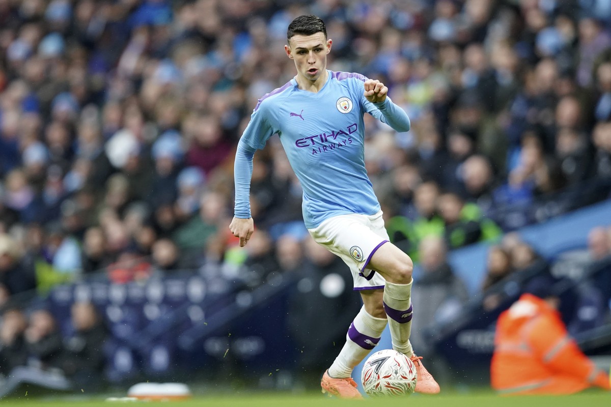Manchester City's Phil Foden runs with the ball during an English FA Cup fourth round soccer match between Manchester City and Fulham at the Etihad Stadium in Manchester, England, Sunday, Jan. 26 ...