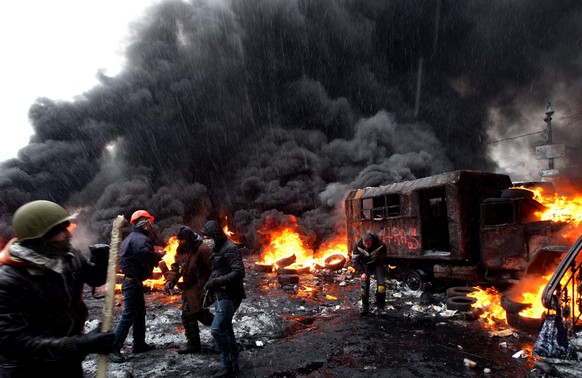 epa04499133 (FILE) A file picture made available 22 November 2014 shows protesters clashing with riot police during an anti-government protest in downtown Kiev, Ukraine, 22 January 2014. Euromaidan, o ...