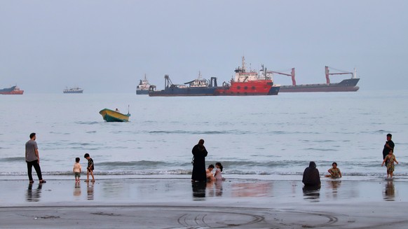 People spend time at a beach as commercial vessels are anchored in the Strait of Hormuz off Bandar Abbas, Iran, Wednesday, Aug. 5, 2026. (Amirhosein Khorgooi/ISNA via AP)
Iran War Strait of Hormuz