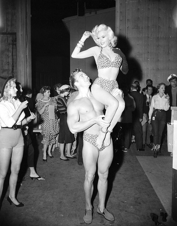 Pin-up star Jayne Mansfield sits on the shoulders of her husband, Mickey Hargitay, on October 30, 1956. They are dressed in leopard print bathing suits for the Ballyhoo Ball, sponsored by the Hollywoo ...