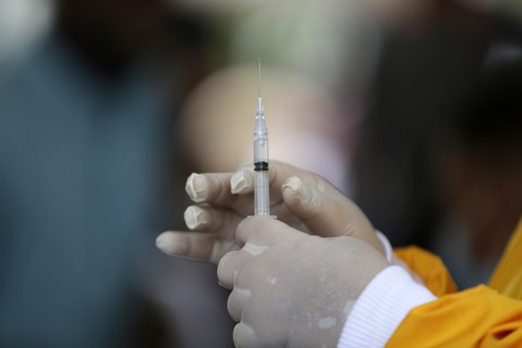 epa09327912 A medical worker prepares a dose of Sinovac vaccine during a mass vaccination for locals in Banda Aceh, Indonesia, 07 July 2021. Indonesia has officially recorded 2,345,018 confirmed COVID ...