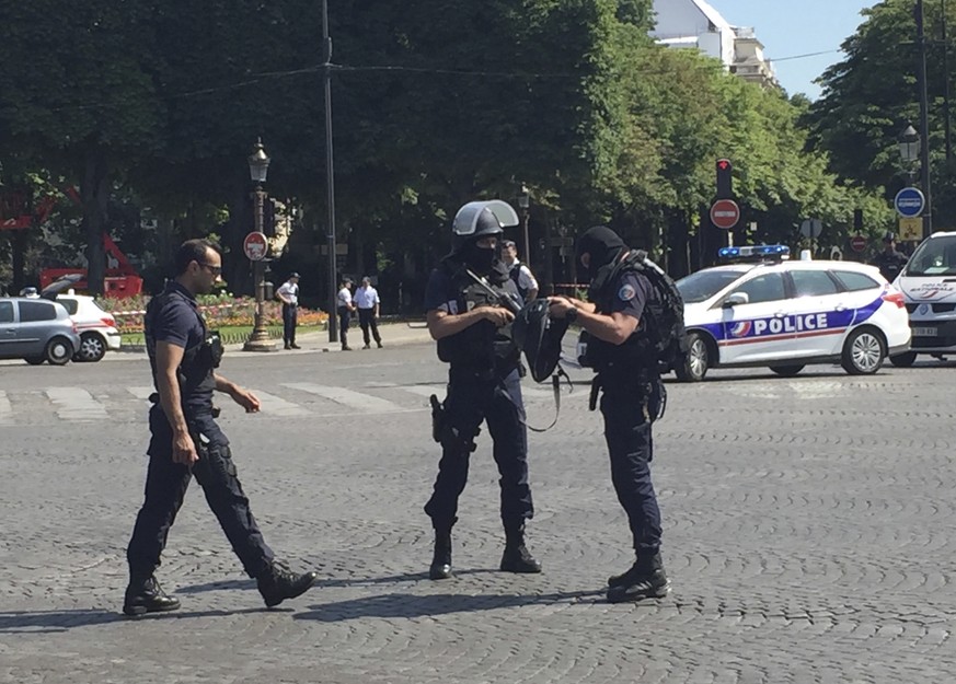 Police officers seal off the access to the Champs Elysees avenue in Paris, France, Monday, June 19, 2017. Paris officials say : Suspected attacker &#039;downed&#039; after driving into police car on C ...