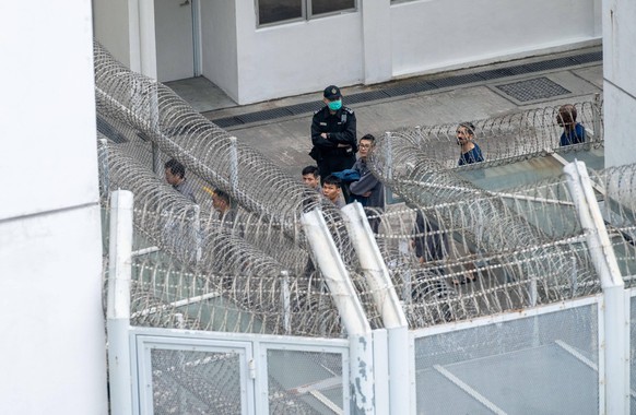 December 12, 2020, Hong Kong, China: Prisoners march inside the prison under the supervision of a person guard at Lai Chi Kok detention center.  The Lai Chi Kok Shelter is a maximum ...