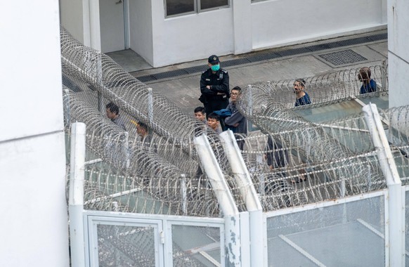 December 12, 2020, Hong Kong, China: Prisoners seen marching within the prison under the supervision of a person guard at the Lai Chi Kok Reception Centre..The Lai Chi Kok Reception Centre is a maximu ...