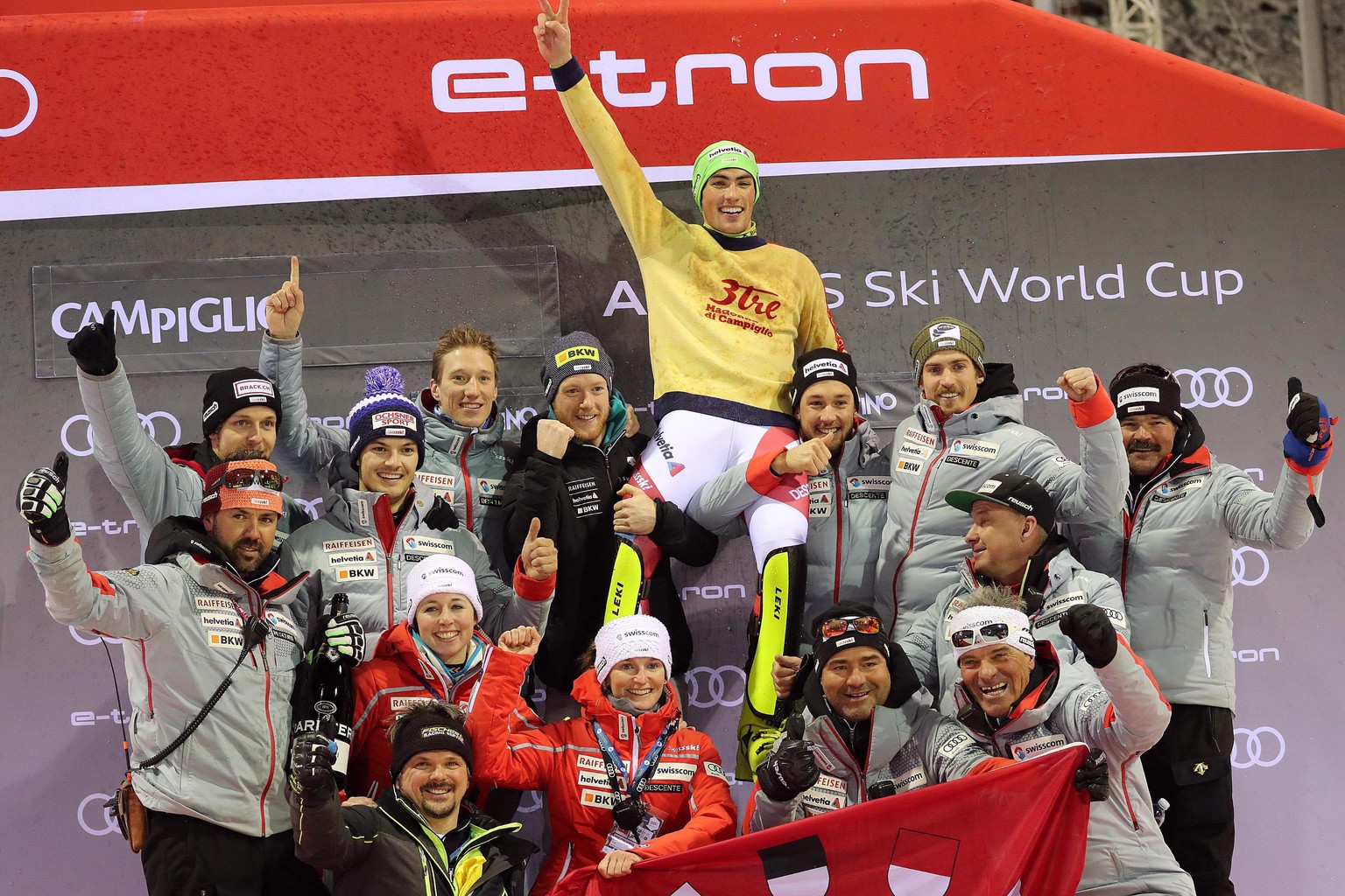 epa07245855 Winner Daniel Yule (C) of Switzerland with his team celebrate on the podium after the Men&#039;s Slalom race at the FIS Alpine Skiing World Cup in Madonna di Campiglio, Italy, 22 December  ...