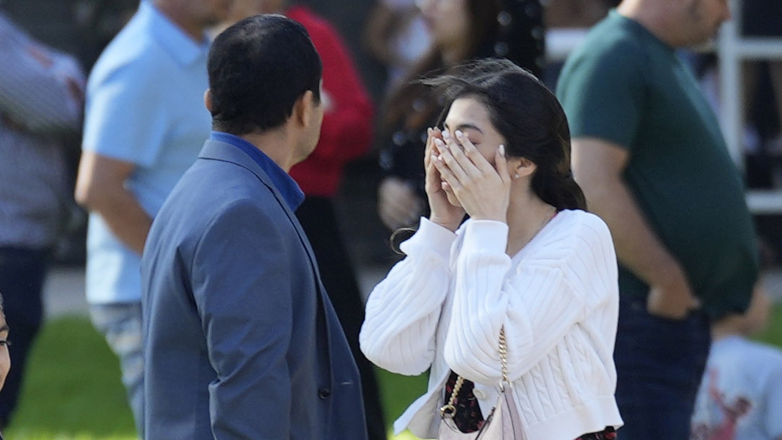 A woman holds her face as she waits with others outside Lakewood Church, Sunday, Feb. 11, 2024, in Houston, after a reported shooting during a Spanish church service.  (Karen Warren/Houston Chronicle f...